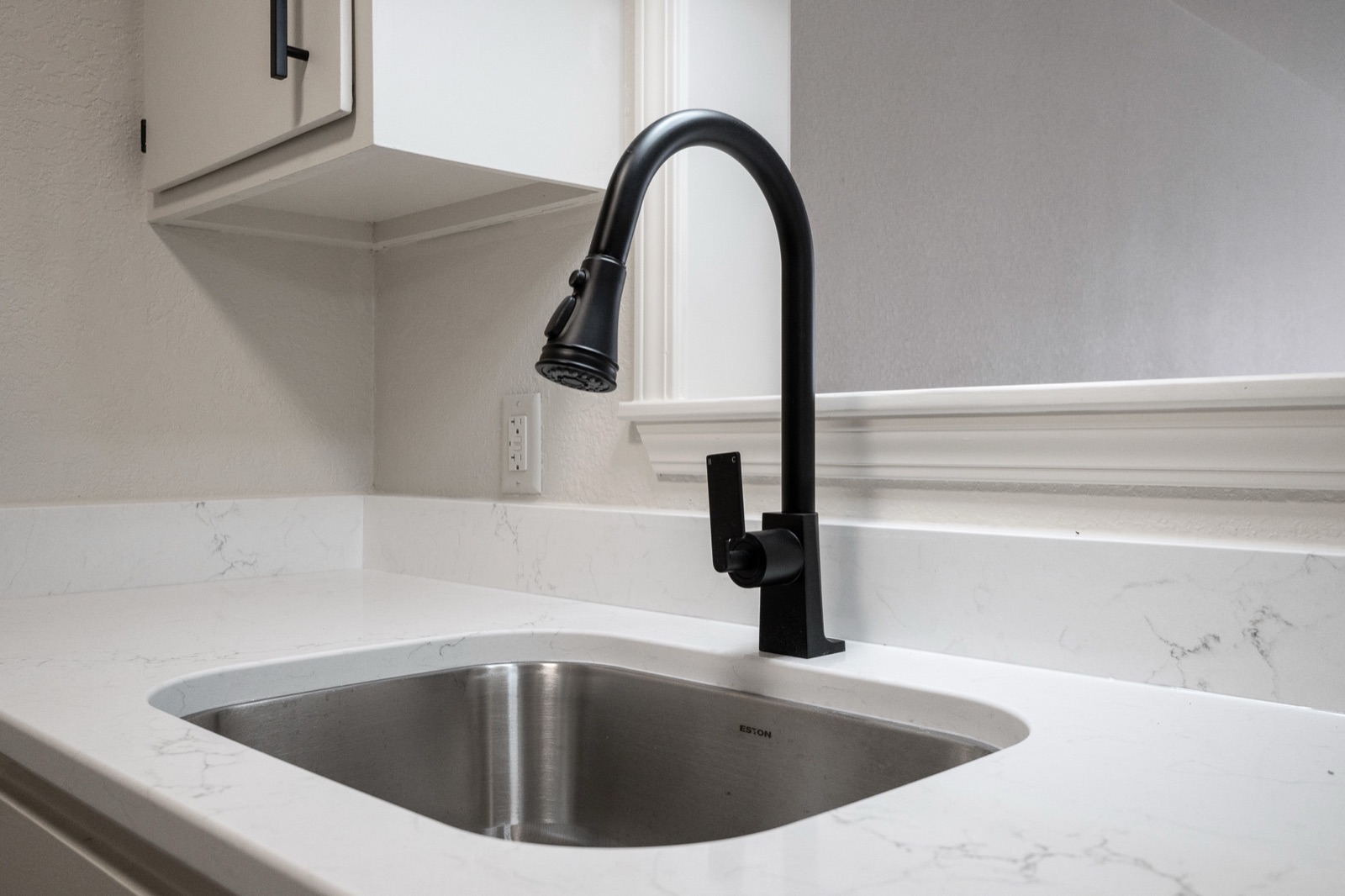 Quartz countertop with matte black faucet