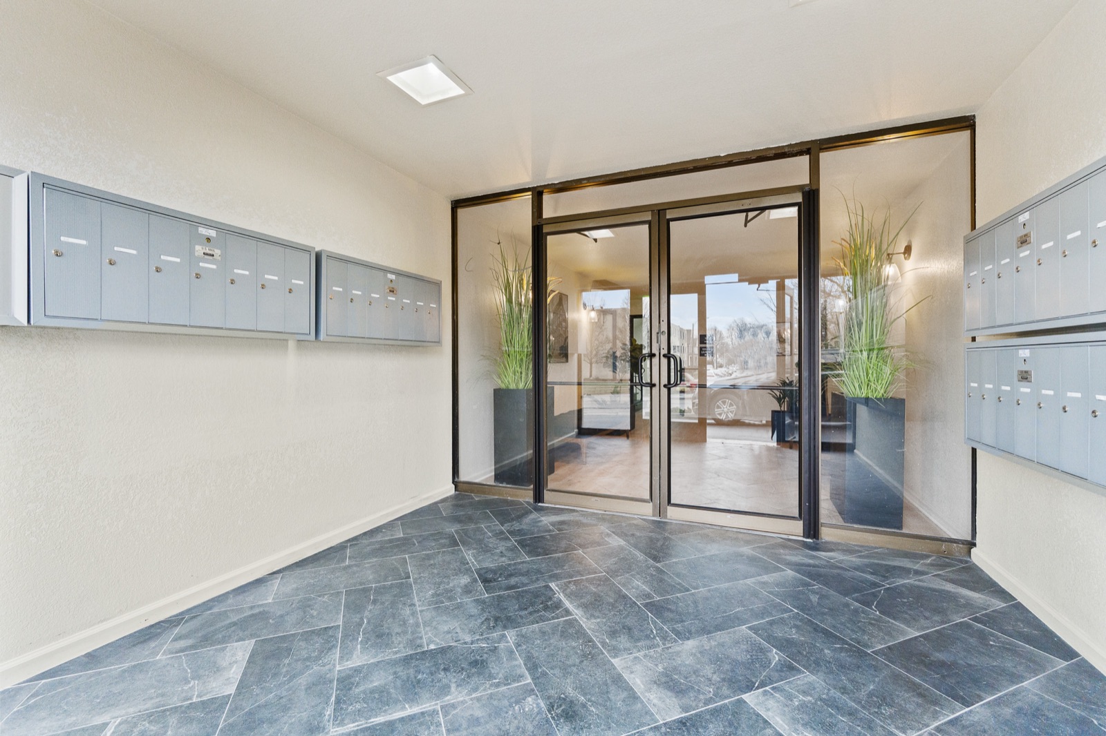 Mailbox vestibule with stone flooring